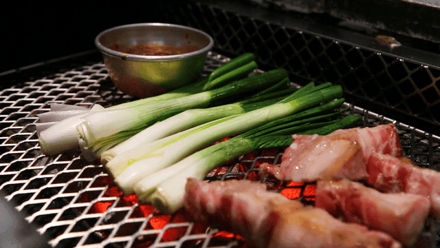 Green onions and pork belly at barbecue