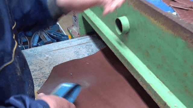 Worker operating leather and glove cutting machine