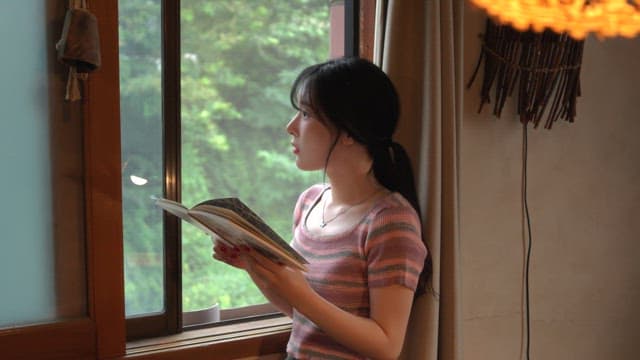 Woman reading by the window