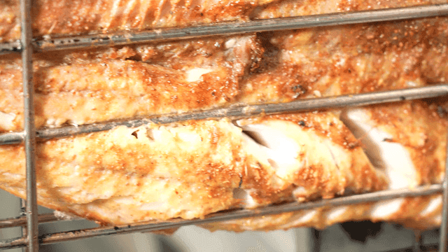 Crispy grilled fish fixed on grill