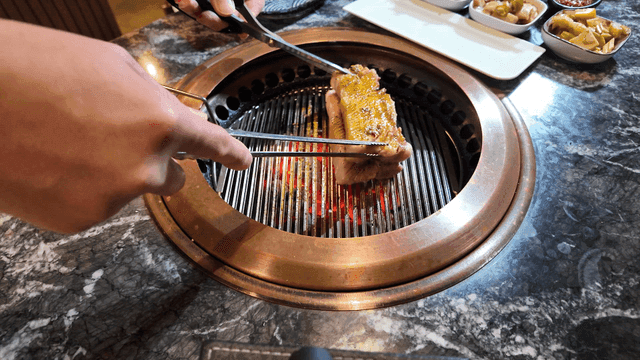 Pork belly grilled overlapping on Korean barbecue grill