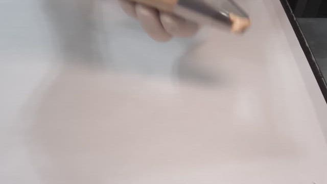 Piping batter onto a baking sheet in a professional kitchen