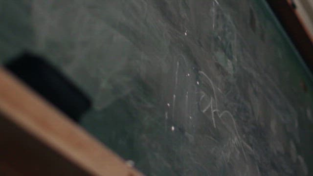 Close-up View of a Chalkboard and Eraser