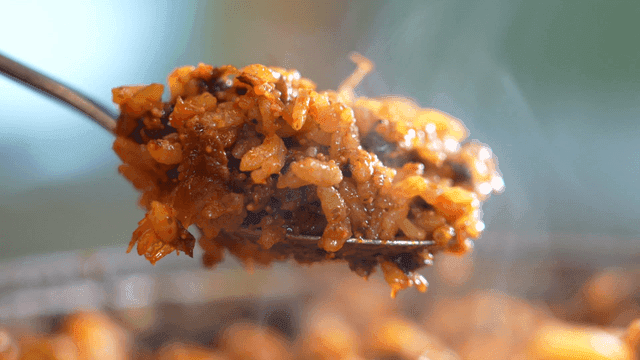 Fried rice being stirred in a pan