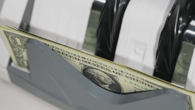 Counting machine processing dollar bills