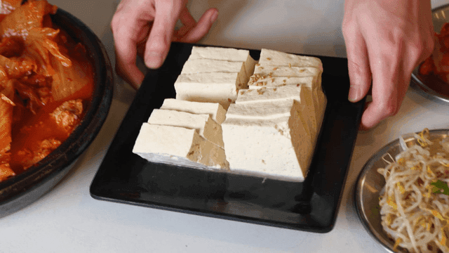 Kimchi stew and tofu on a table