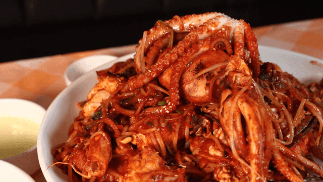 Spicy octopus seafood stew on table
