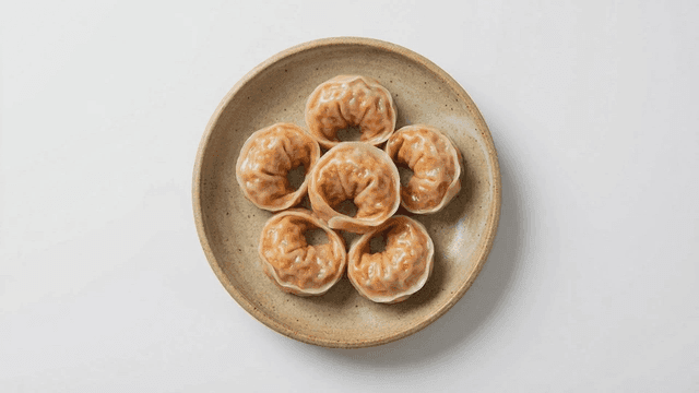 Plate of neatly arranged steamed kimchi dumplings