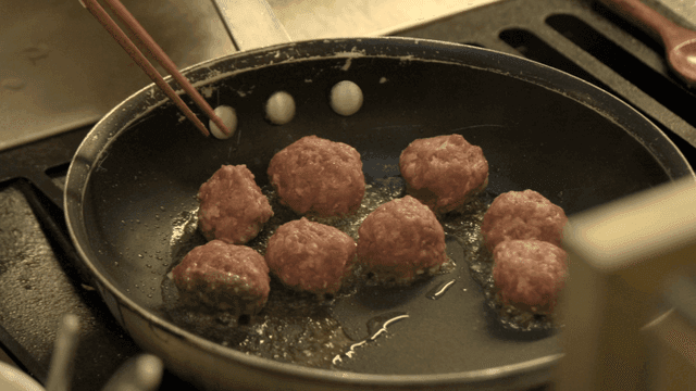 Meatballs cooking in frying pan