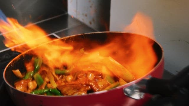 Cooking Chicken Stir Fry witn Pan on Stove