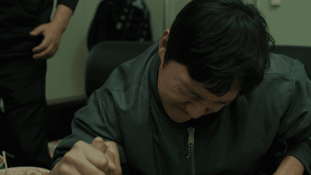 A man arm wrestling with determination