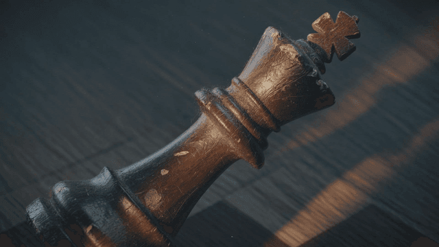 Wooden king on chessboard