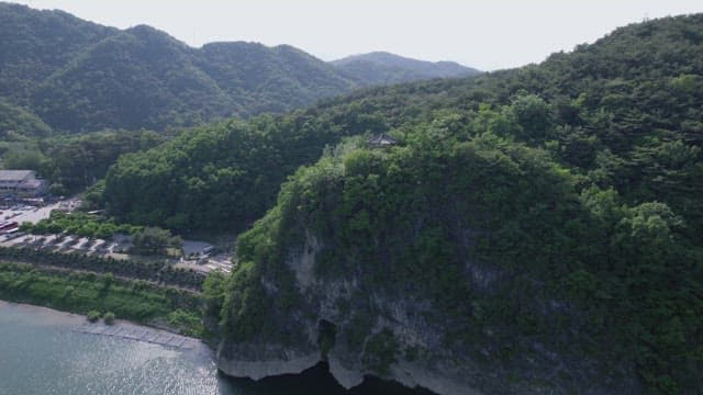 푸른 나무가 우거진 산자락 끝에 자리한 고요한 호수