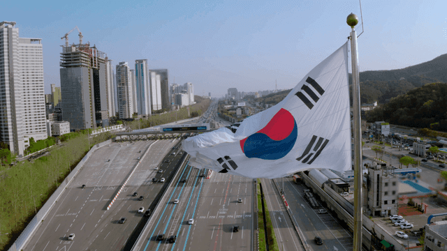 A busy highway with a Korean flag