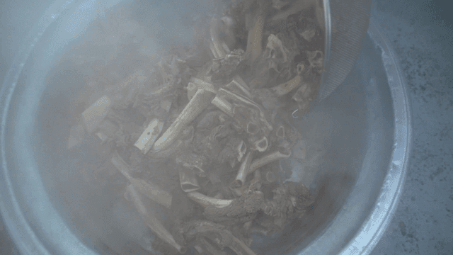 Sieve for scooping out beef bones from large pot