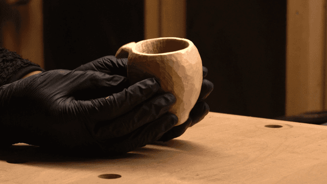 실내에서 나무 컵을 만드는 손