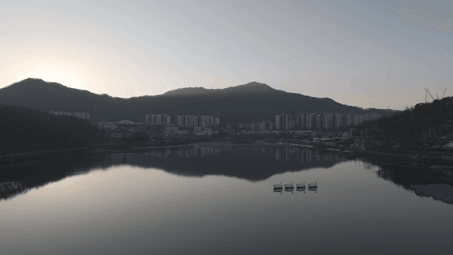 Tranquil lake reflecting city apartments