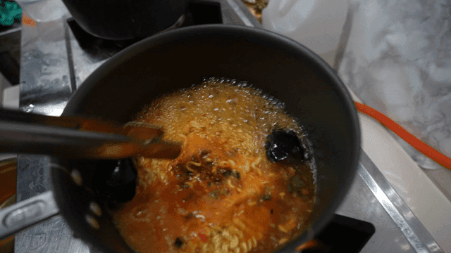Cooking ramen with seafood in a pot