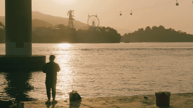 Fishing by the riverside at sunset