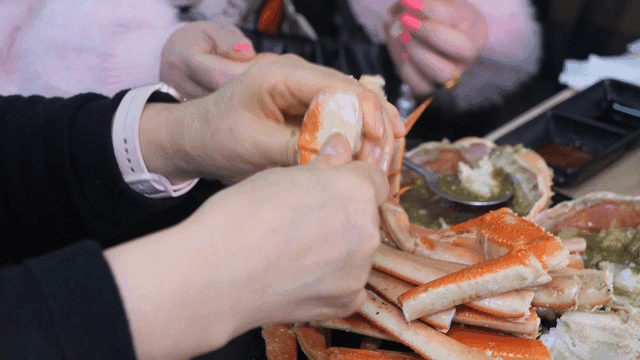 People eating fresh steamed snow crab