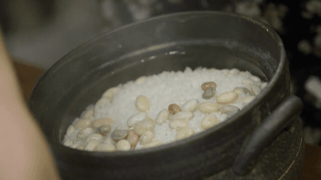 Cooking rice with beans in a traditional pot
