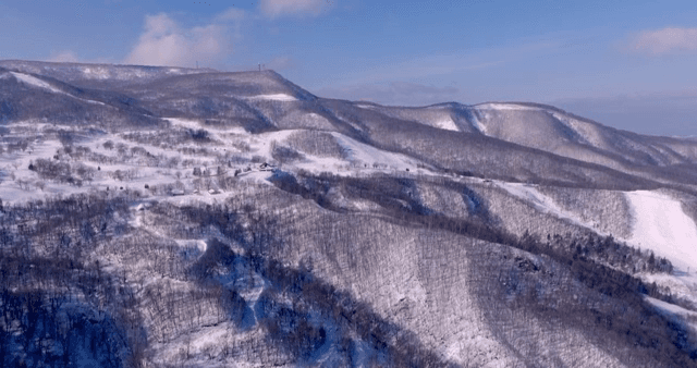 Snow-covered mountains under a clear sky