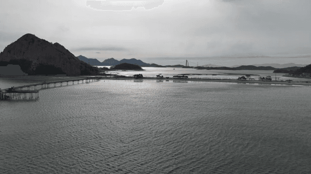 A serene coastal landscape with mountains