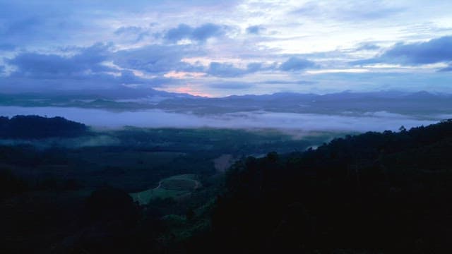 Misty mountains at dawn with clouds