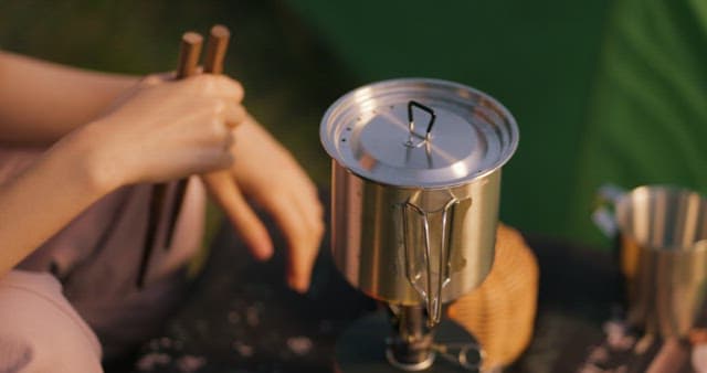 Person Making Ramen for a Camping Night Snack