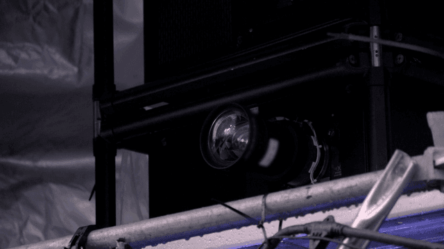 Close-up of a camera lens in a studio