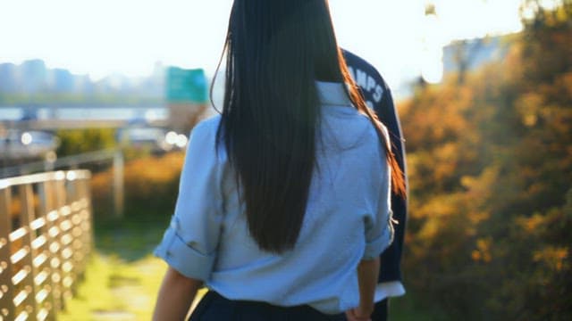 Couple walking hand in hand on a sunny day