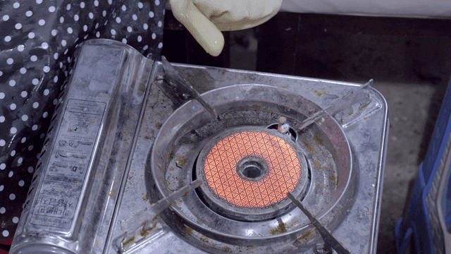 Warming hands over gas burner