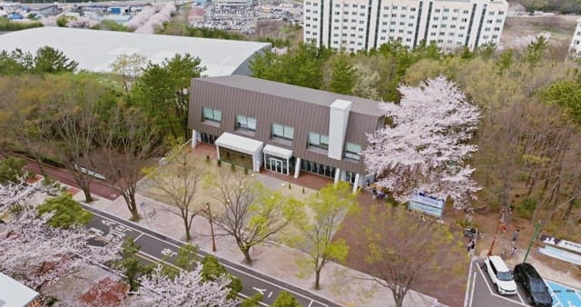 Modern building surrounded by cherry blossoms