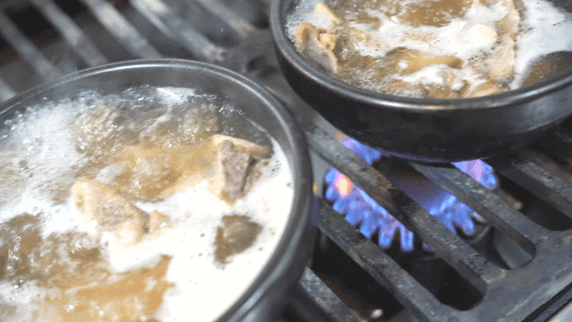 Beef rib soup boiling on gas stove