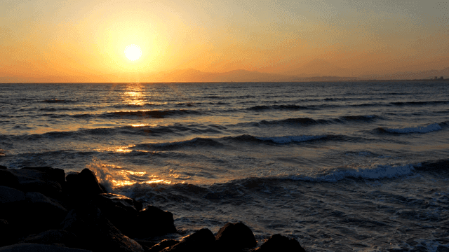 Gentle waves and sunset over sea