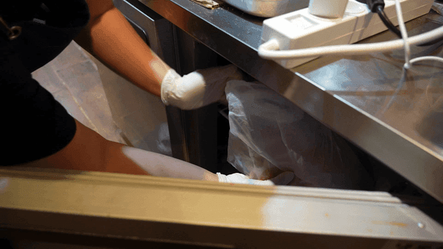 Person retrieving ingredients from a fridge