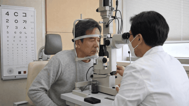 Elderly man receiving eye exam at clinic