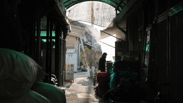Person walking through a narrow alley