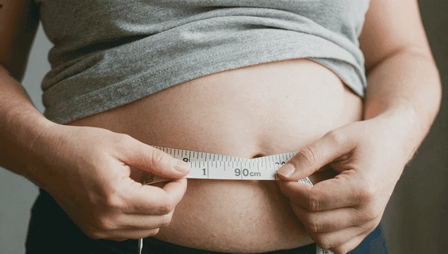 Woman checking her belly circumference