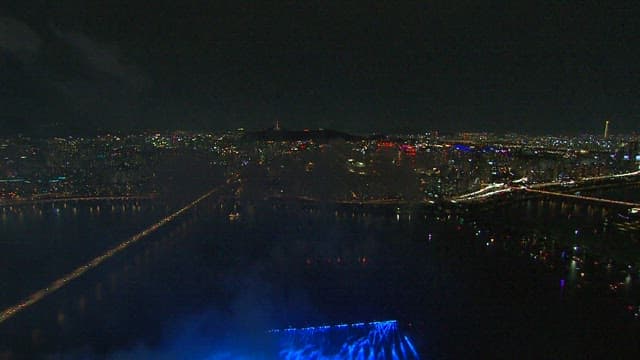 Spectacular Fireworks over the Cityscape and River at Night