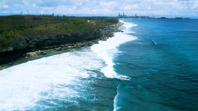 Waves Crashing Against the Tropical Coastline