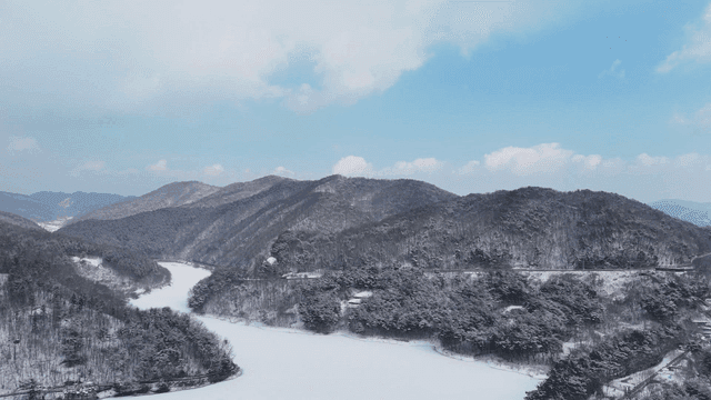 Snow-covered mountains and a frozen river