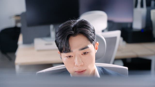 Man stretching at his office desk