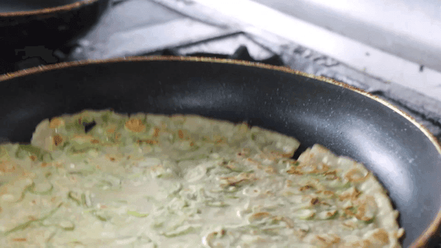 Korean buckwheat pancake cooking in a pan