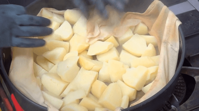 Potatoes being steamed in a pot