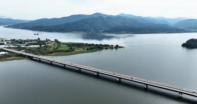 Scenic river with a bridge and mountains