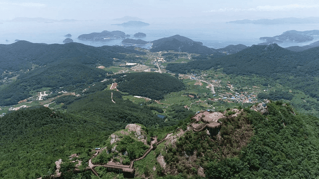 Mountain top view with city and sea