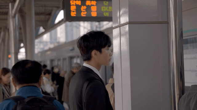 Office worker man waiting for subway at crowded subway station