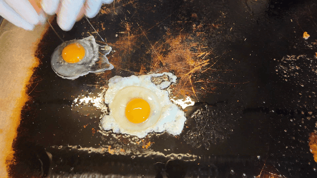 Fried eggs on hot iron plate