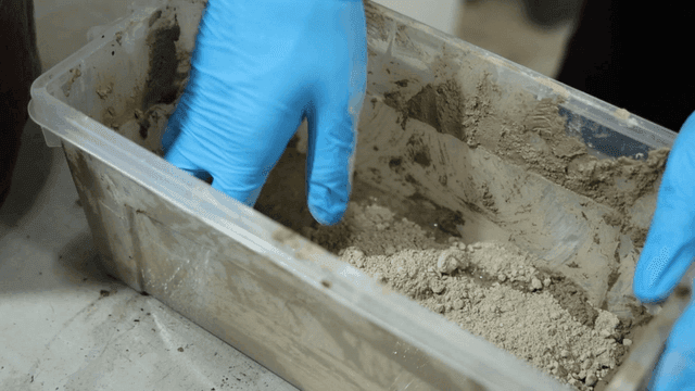 Hand mixing ingredients in plastic container